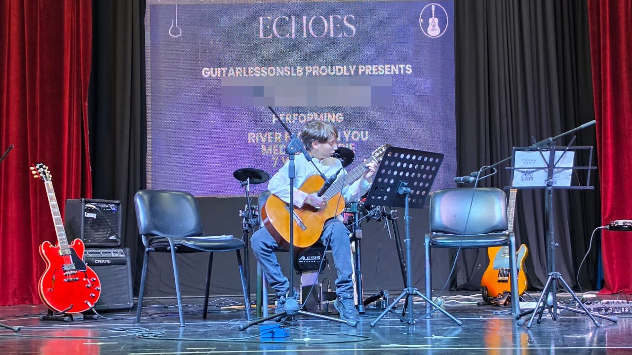 A young student playing classical guitar on the Echoes stage